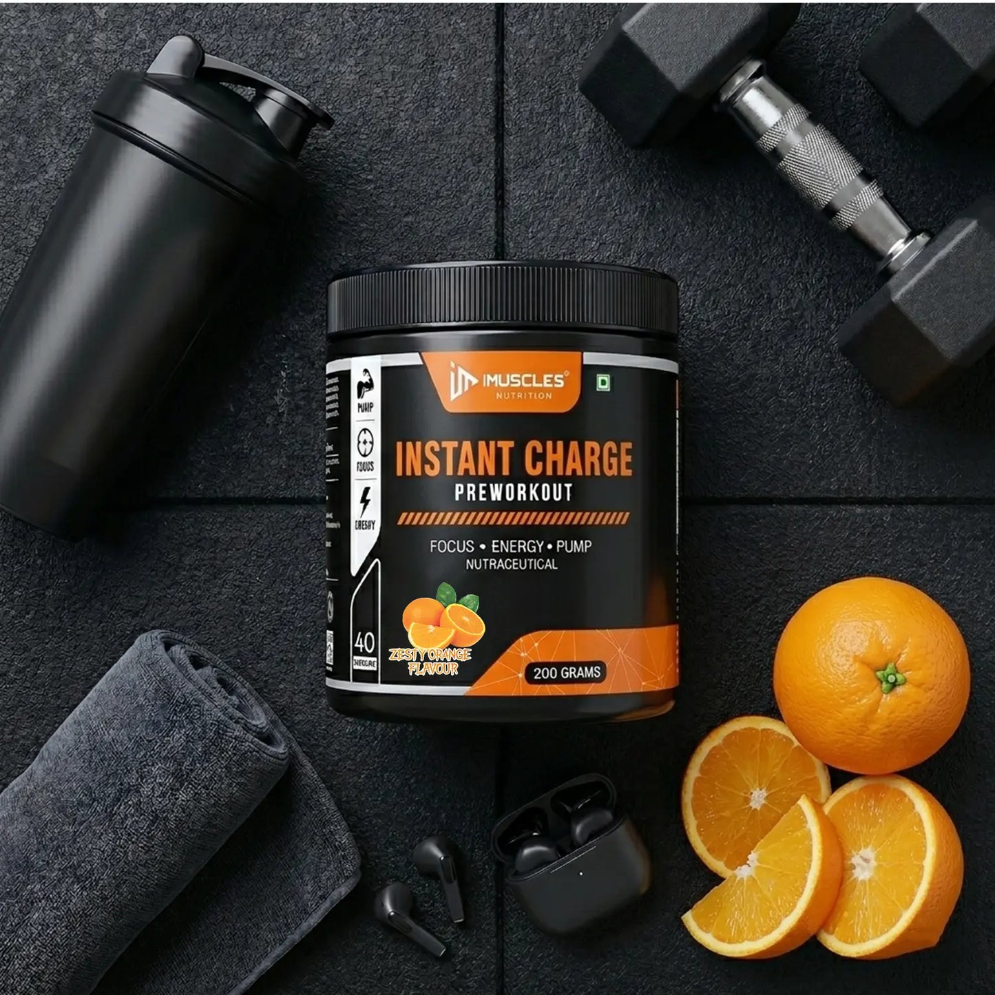 A flat-lay product promotional banner titled "Zesty Orange 13.jpg" featuring an iMuscles Nutrition "INSTANT CHARGE" pre-workout jar on a gym floor surface. The scene includes a shaker bottle, a folded towel, wireless earbuds, a dumbbell, and fresh orange slices, emphasizing a lifestyle-focused and energetic branding aesthetic.