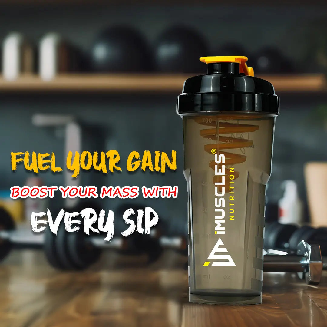 A promotional banner for iMuscles Nutrition, referenced as 7.1.jpg. The left side features bold text reading "LOVED AND RECOMMENDED BY THOUSANDS" followed by the tagline "Fuel Your Fitness. Shake Smarter With iMuscles." The right side shows a collage of lifestyle settings, with the central focus on a sleek, dark translucent iMuscles shaker bottle resting on a gym bench. Other background elements include a home office setup and a yoga mat with a bowl of fruit.