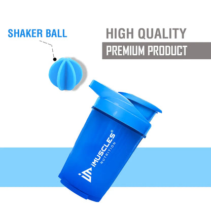 A promotional banner for the iMuscles Nutrition blue shaker bottle titled blue  1.png. On the left side, bold navy blue text on a light blue background reads "SHAKE UP SUCCEED" and "YOUR FITNESS GAME CHANGER." The right side showcases a 500 ml vibrant blue shaker bottle and a matching blue mixing ball, with labels highlighting "VERSATILITY" and "500 ML."