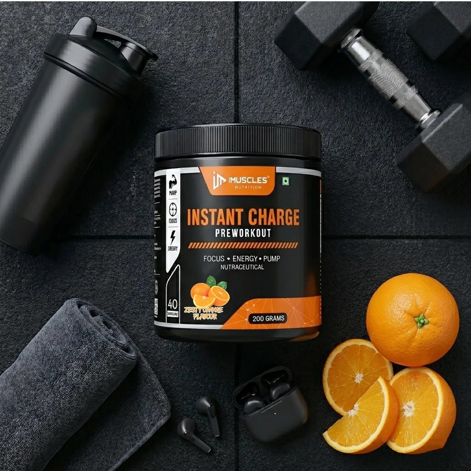 A flat-lay product promotional banner titled "Zesty Orange 13.jpg" featuring an iMuscles Nutrition "INSTANT CHARGE" pre-workout jar on a gym floor surface. The scene includes a shaker bottle, a folded towel, wireless earbuds, a dumbbell, and fresh orange slices, emphasizing a lifestyle-focused and energetic branding aesthetic.