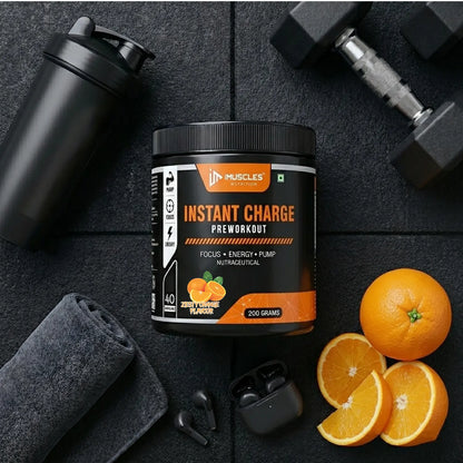 A flat-lay product promotional banner titled "Zesty Orange 13.jpg" featuring an iMuscles Nutrition "INSTANT CHARGE" pre-workout jar on a gym floor surface. The scene includes a shaker bottle, a folded towel, wireless earbuds, a dumbbell, and fresh orange slices, emphasizing a lifestyle-focused and energetic branding aesthetic.