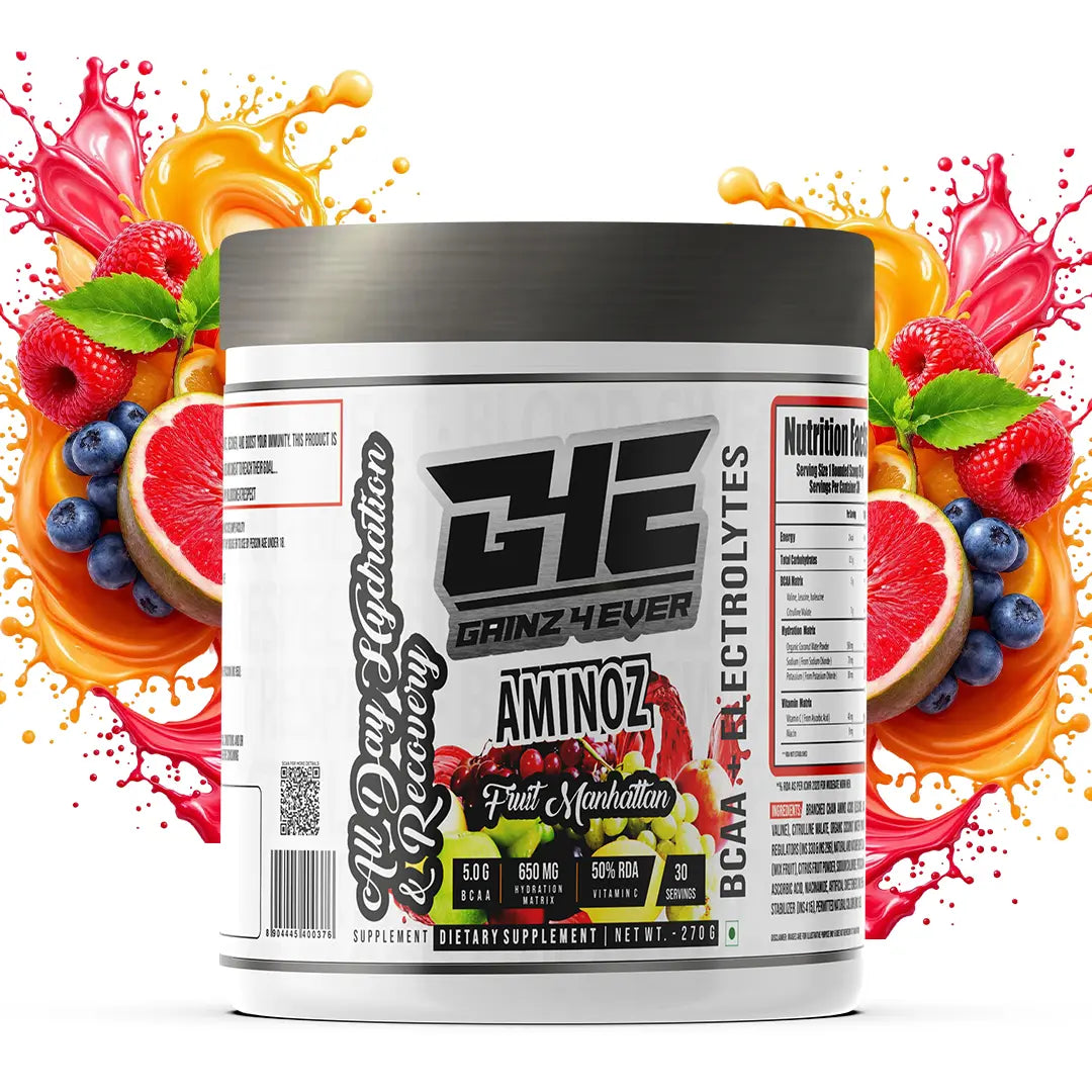 Promotional image for GAINZ 4 EVER AMINOZ Fruit Manhattan flavor. The white 270g supplement jar is positioned in the center, surrounded by vibrant splashes of red and orange liquid, fresh raspberries, blueberries, grapefruit slices, and grapes. The label highlights "BCAA + ELECTROLYTES" and "All Day Hydration & Recovery" with 30 servings per container.