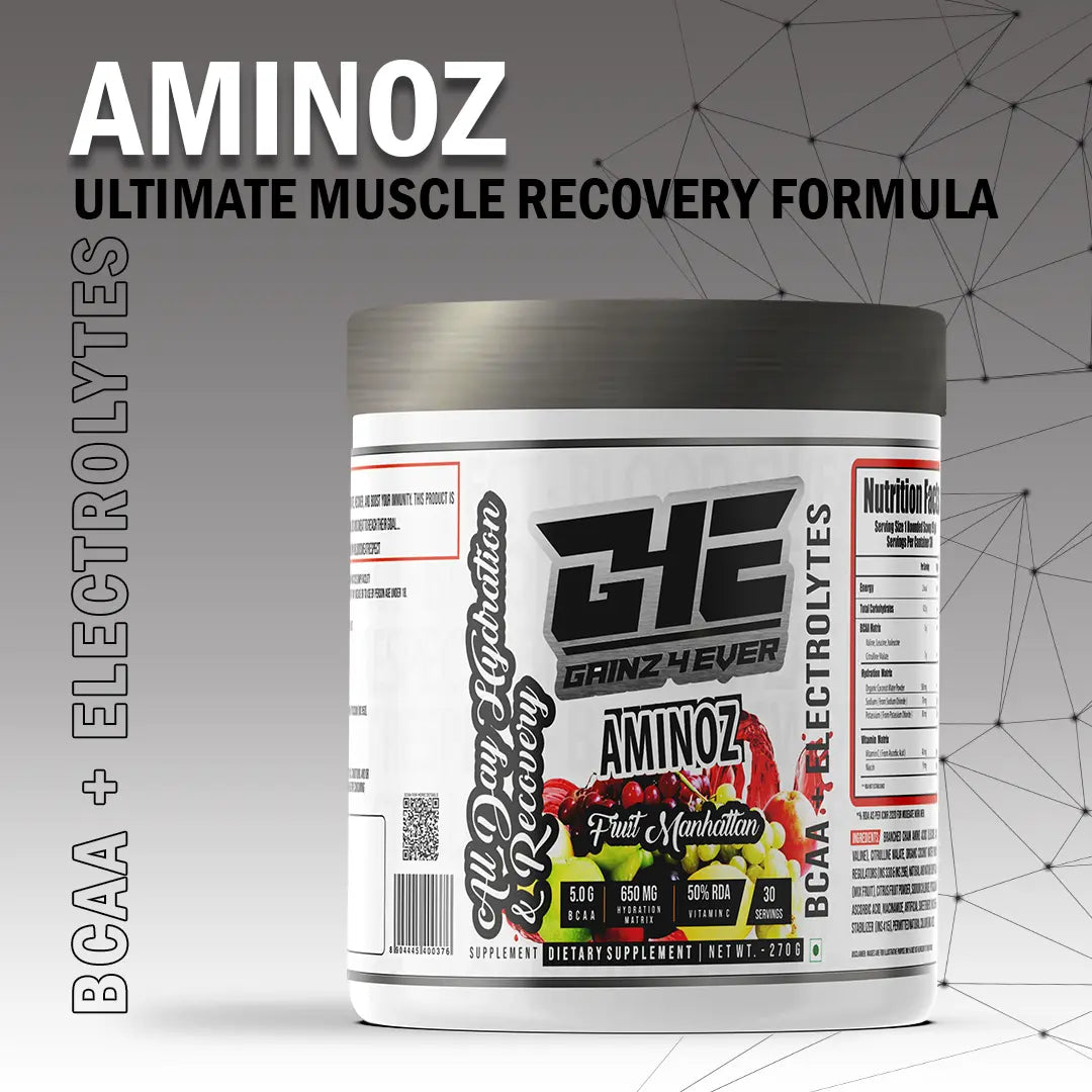 Promotional image for GAINZ 4 EVER AMINOZ Fruit Manhattan flavor. The white 270g supplement jar is positioned in the center, surrounded by vibrant splashes of red and orange liquid, fresh raspberries, blueberries, grapefruit slices, and grapes. The label highlights "BCAA + ELECTROLYTES" and "All Day Hydration & Recovery" with 30 servings per container.