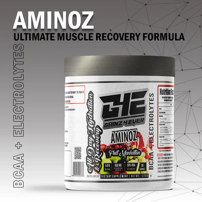 Promotional image for GAINZ 4 EVER AMINOZ Fruit Manhattan flavor. The white 270g supplement jar is positioned in the center, surrounded by vibrant splashes of red and orange liquid, fresh raspberries, blueberries, grapefruit slices, and grapes. The label highlights "BCAA + ELECTROLYTES" and "All Day Hydration & Recovery" with 30 servings per container.