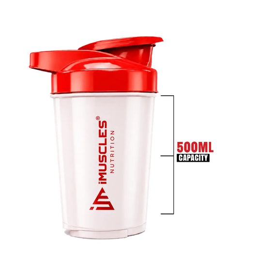 A promotional banner for the iMuscles Nutrition red and white shaker bottle titled red & white 1.png. On the left side, bold dark red text on a light pink background reads "SHAKE UP SUCCEED" and "YOUR FITNESS GAME CHANGER". The right side features a 500 ml shaker bottle with a white body and red lid alongside a matching red mixing ball, labeled with "VERSATILITY" and "500 ML".